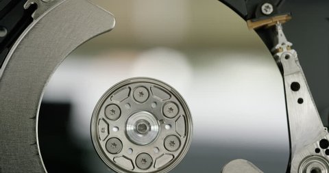 Close up of metal wheel spinning inside a hard drive