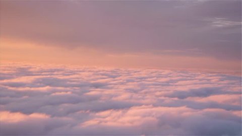 Flying above pretty pink heavenly clouds at sunset. Aerial footage; two different shots.