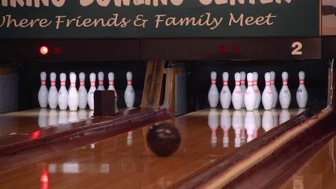 Bowling a strike in slow motion and pins reset.