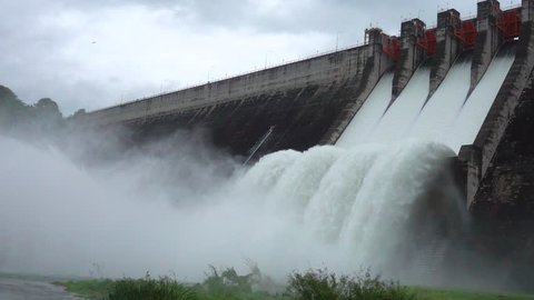 Slow motion of water dam drained from outlet pipe of the dam where is the hydropower electrical generation