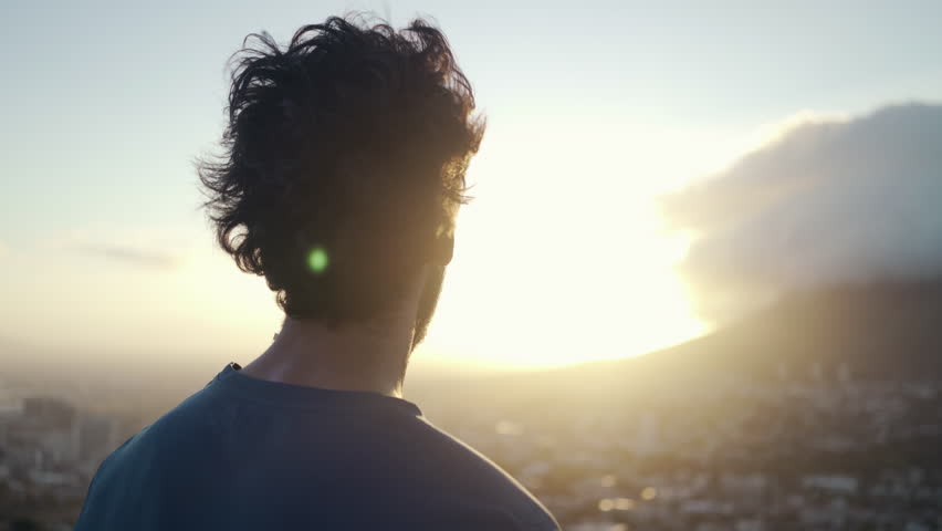 Close up shot a young white male in sportsclothes taking a break from exercising and admiring the view of the city and nature at sunrise Royalty-Free Stock Footage #1026829532