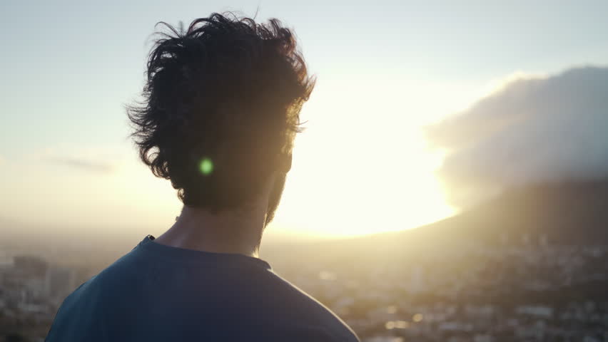 Close up shot a young white male in sportsclothes taking a break from exercising and admiring the view of the city and nature at sunrise | Shutterstock HD Video #1026829532