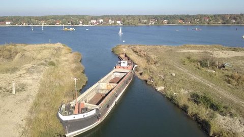 
View of the river "Martwa Wisla" and ships floating on it. The film was prepared in a beautiful autumn scenery.