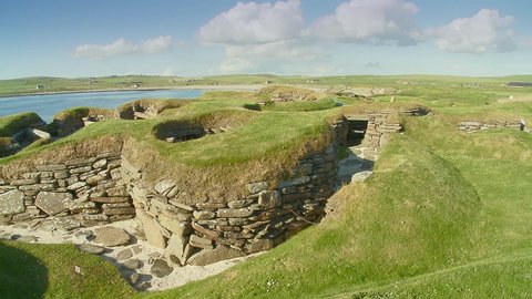 Pan across the Stone neolithic house remains of the prehistoric village of Skara Brae archaeological site, Bay of Skaill , Mainland, Orkney Island, Scotland, 