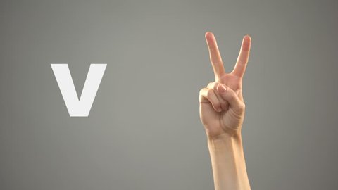 Letter V in sign language, hand on background, communication for deaf, lesson