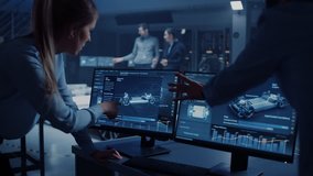 Female and Male Engineers are Discussing the 3D CAD Software Render of an Electric Concept Car. High Tech Laboratory with a Prototype Vehicle Chassis. - Powered by Shutterstock - Get 15% off with code: PIKWIZARD15