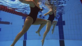 Multiracial couple attending water aerobics class in a swimming pool - Powered by Shutterstock - Get 15% off with code: PIKWIZARD15