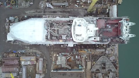 Aerial overview (from drone perspective) on ships being repaired and reconstructed in ship repair yard in Gdansk, Poland. Footage contains also overview of other constructions located in ship repair y