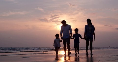 SLOW MOTION, Silhouetted Asian family walking together at Beach. Family, Holiday and Travel concept.