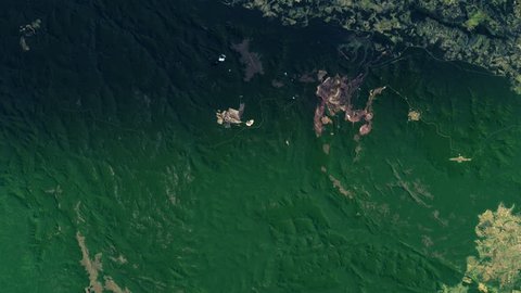 Iron mine in green amazon rainforest satellite view night to day sunrise in Carajas Brazil. Contains public domain image by Nasa