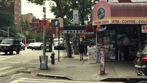 NEW YORK - JUNE 20, 2018: street corner convenience store deli grocery with ATM and phone cards east side Manhattan New York City NYC 4K and 1080HD. The city is populated with many convenience stores.
