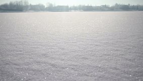 Glowing Shining Snow On A Frozen River On A Sunny Winter Day. Accelerated Slider Dolly Video Shot.