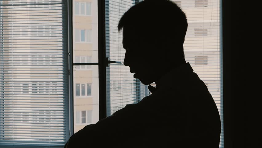 Silhouette of a man dressed in the room