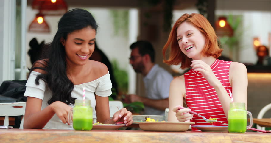 two female multiracial women eating restaurant: стоковое видео (без лицензи...