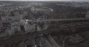 4K. Aerial view of high-speed trains passing through the center of Warsaw. Trains passing through the yellow buildings by the river Vistula. Taken from the drone in RAW  format.