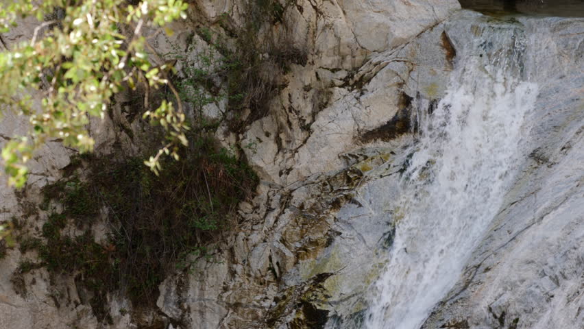 Switzer Falls Angeles National Forest California Slow Motion Water Falling Branch in Foreground Rack Focus