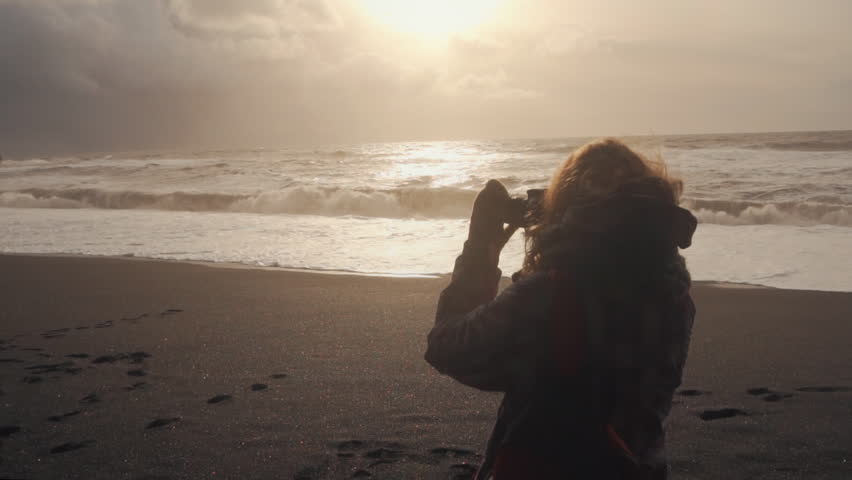 Tourist photographer taking photo at sunset