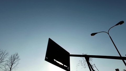 Abandoned Backboard Without Basket on Basketball Field Silhouette on Sunny Afternoon 4k