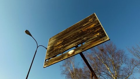 Abandoned Basketball Backboard Without Basket and Net on Outdoor Field Under Streetlight on Sunny Afternoon 4k