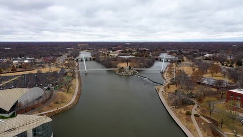 Aerial video of the Keeper of the Plains near downtown Wichita, Kansas on a cloudy day.