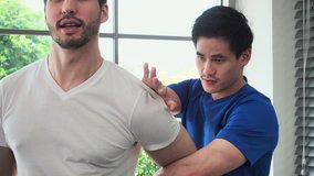Physical therapist stretching upper arm and shoulder muscles of athlete male patient - Powered by Shutterstock - Get 15% off with code: PIKWIZARD15