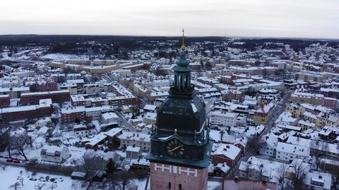 Drone footage circle around the tower of the old cathedral of Strängnäs with the old town in the background. Filmed in realtime at 4k.