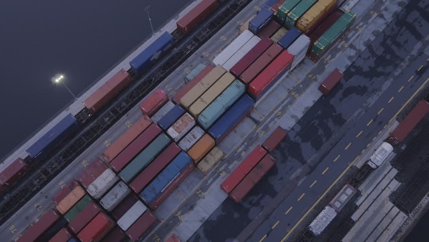 The drone rises above the colorful intermodal containers.