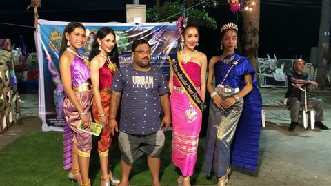 A group of gorgeous ladyboy is photographed with tourists on the embankment of Pattaya, Suanthai. Pattaya, Thailand, 03.04.2019