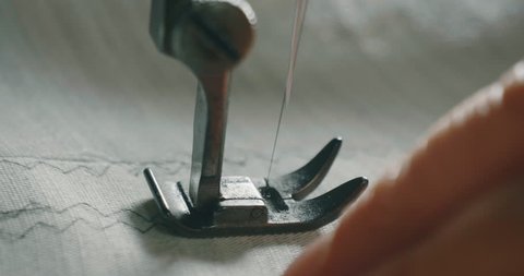Slow motion close up of tailor sewing handmade great quality suit or shirt in ancient traditional atelier.