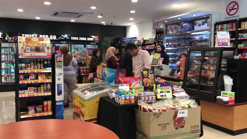 SHAH ALAM, MALAYSIA - March 29, 2019 : 4K footage, Interior view of customers at cashier counter queuing to make payment at 7-Eleven convenience store.