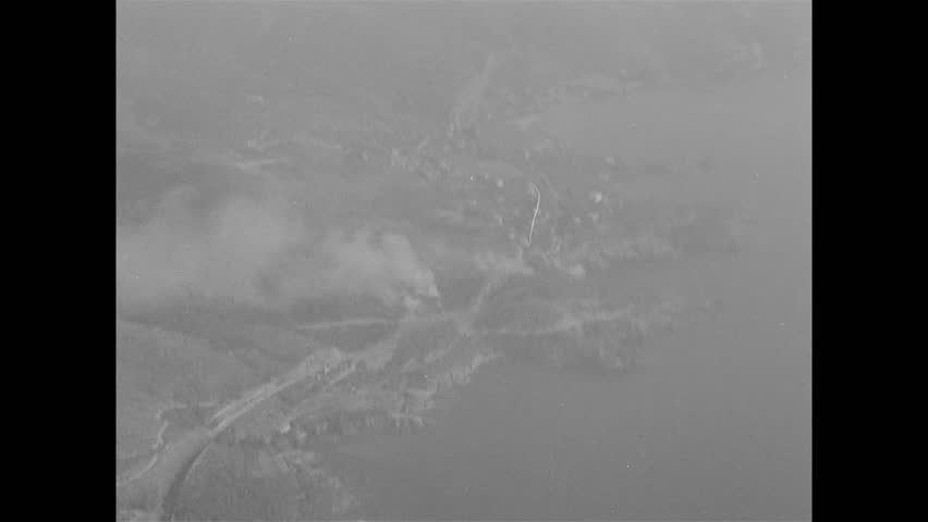CIRCA 1944 - American paratroopers are dropped from C-47s over France.