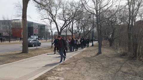 Toronto, Canada - Apr 4, 2019: Humber College students with posters participate in Ontario protest rally demonstration walk against Doug Ford provincial government's changes to the education system.