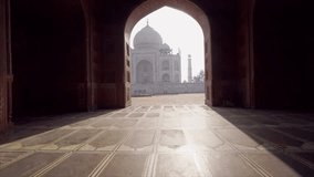 Follow me to the Taj Mahal, India. Female tourist leading boyfriend to there magnificent famous Mausoleum in Agra. People travel concept - Girl holding man hand at sunrise traveling together- Slow mo