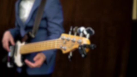 Playing the electric guitar, a completely blured image. Only guitar and hands.