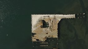 Aerial video of Old Abandoned dock with birds flying past in Northern California Bodega Bay