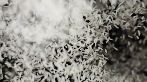 White basmati rice seeds bouncing against camera black background. Pile of rice grains flies in slow motion