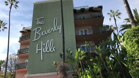 LOS ANGELES, March 30th, 2019: Low angle close up shot of the Beverly Hills Hotel facade, surrounded by palms and a blue sky. The iconic hotel is owned by the Sultan of Brunei.