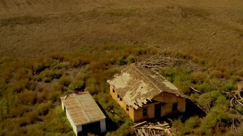 Arial drone footage of abandoned farm in Texas USA. Fly by in spiral motion.