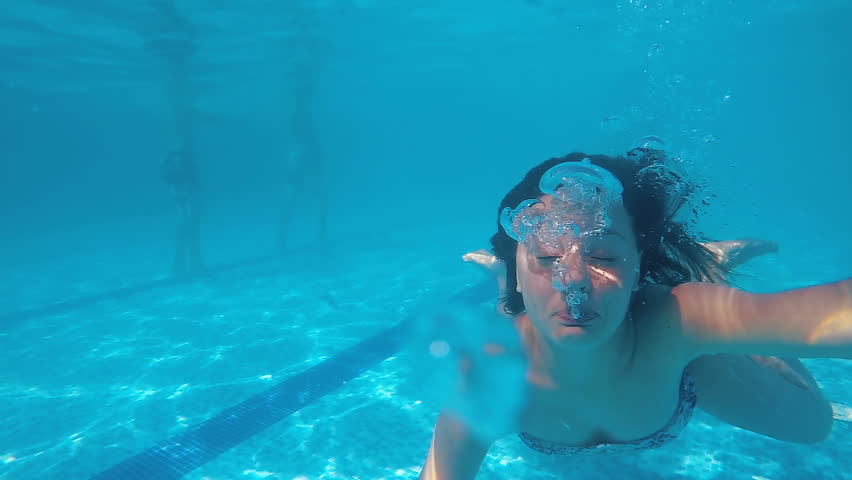 Drowning teen swimming in panic underwater in pool making bubbles, slow motion | Shutterstock HD Video #1026967550