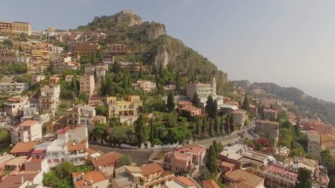 An impressive aerial flight over Taormina, Italy from the lemon trees to the mountain's summit