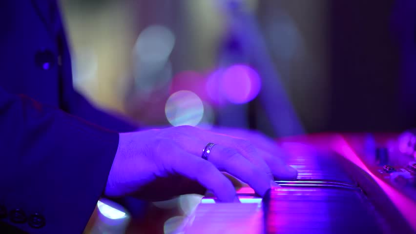 Bright performance of musicians on the stage. Close-ups of musicians while playing musical instruments. Musicians in the bright lights on stage. Royalty-Free Stock Footage #1026978266