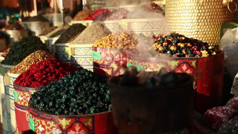Slowmotion shot of different spices and flavours on a market.