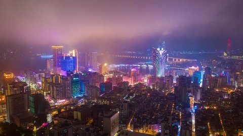 night illumination flight over macau city hotel downtown bay aerial panorama 4k timelapse china
