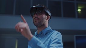 In 3D Content Creating Laboratory Engineer Wearing Professional Virtual Reality Headset Works and Gestures in Augmented Reality. Stylish Low Angle Arc Portrait Shot - Powered by Shutterstock - Get 15% off with code: PIKWIZARD15