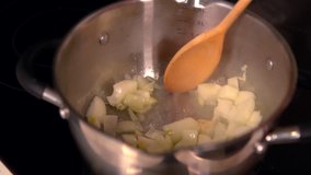 Woman cooking diced onion and potato