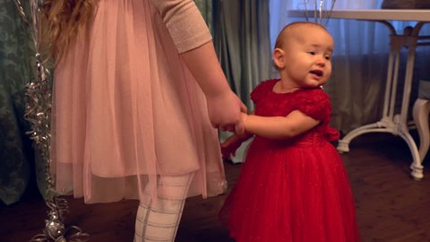 Cute baby girl in a red party dress