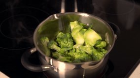 Steaming hot pot of fresh broccoli cooking