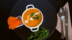 Rotating bowl of tasty homemade pumpkin soup