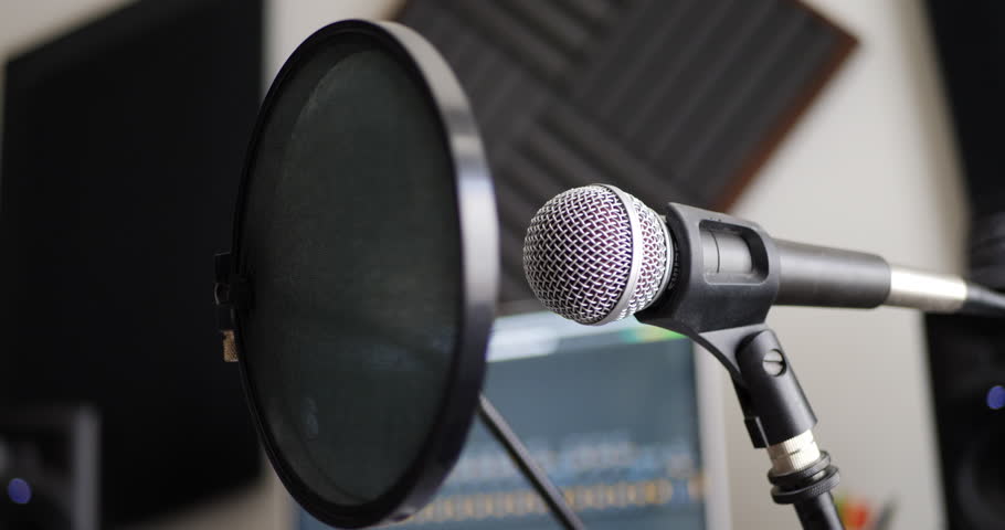 A vocal microphone and pop filter for singing or recording a podcast in a bedroom music studio SLIDE LEFT.