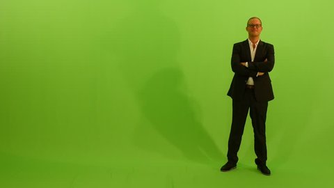 businessman walking into the frame. isolated green screen background.